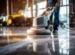 Worker polishing a hard floor with a high-speed machine during floor stripping and waxing