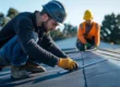 Two workers performing Phoenix commercial roof maintenance on a flat roof